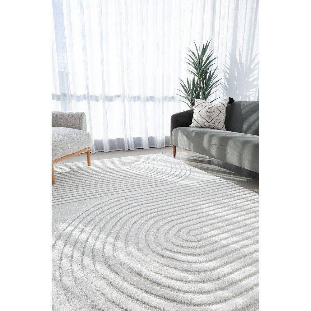 Lotus Abbey White Rug featuring ripple concentric circle pattern in white on ivory background, hand-tufted wool