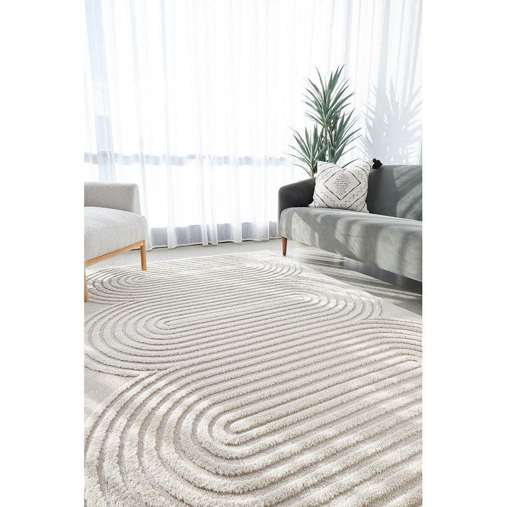 Lotus Carl Beige Rug featuring concentric wave pattern in beige, cream, taupe on ivory background, hand-tufted wool