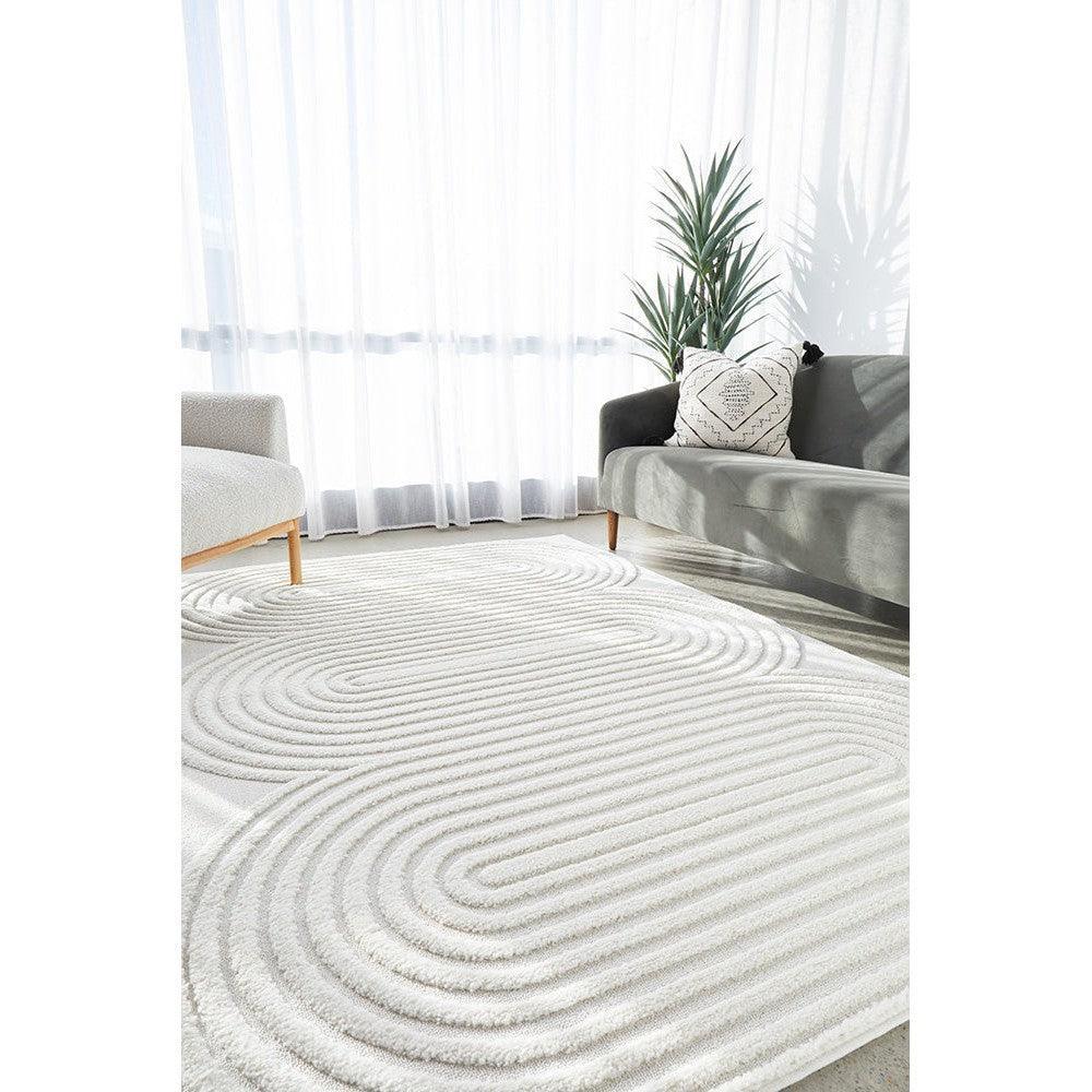 Lotus Carl White Rug featuring concentric spiral pattern in ivory and white on cream background, machine-made polypropylene