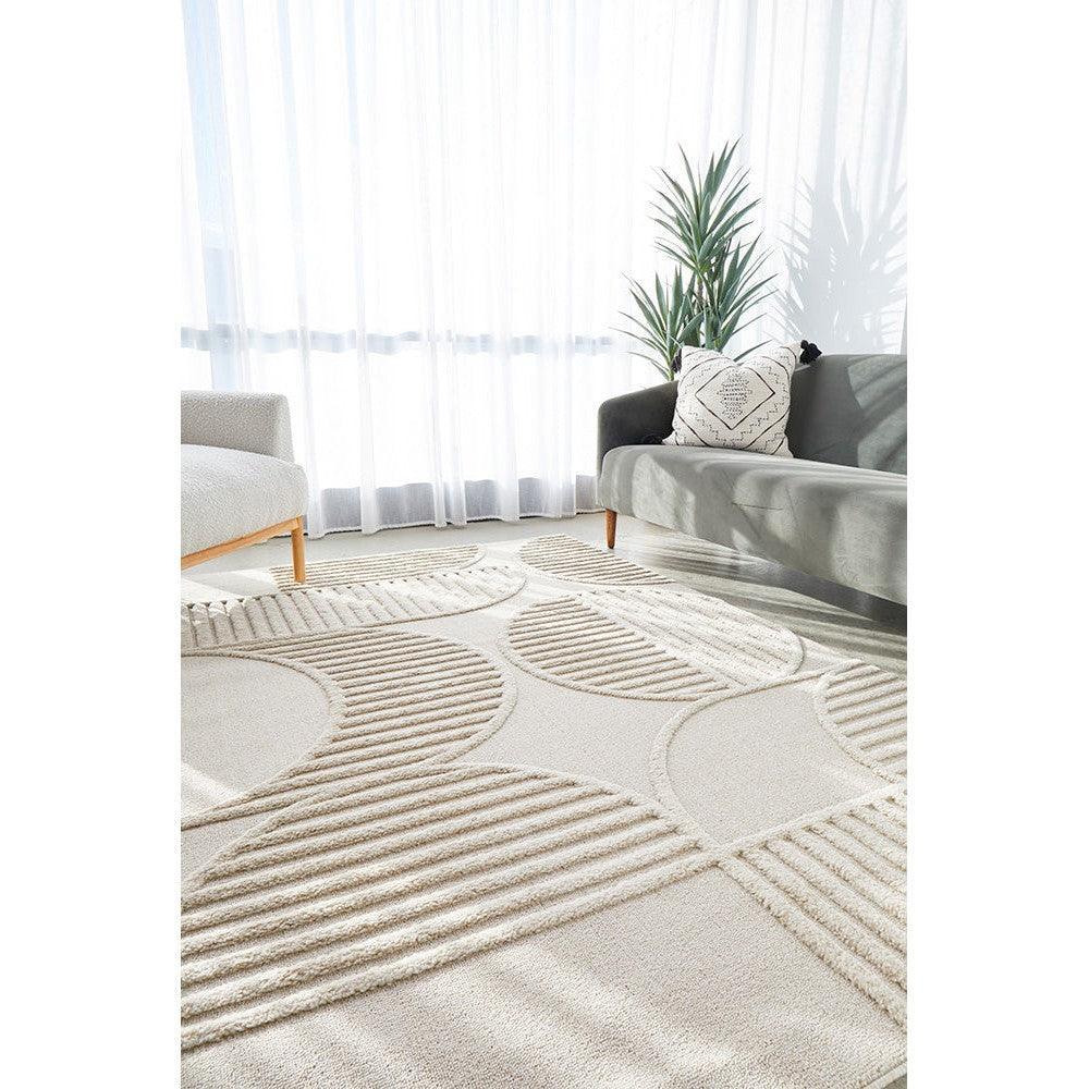 Lotus Leo Beige Rug featuring geometric circular striped pattern in cream, beige and taupe on light ivory background, machine-made wool