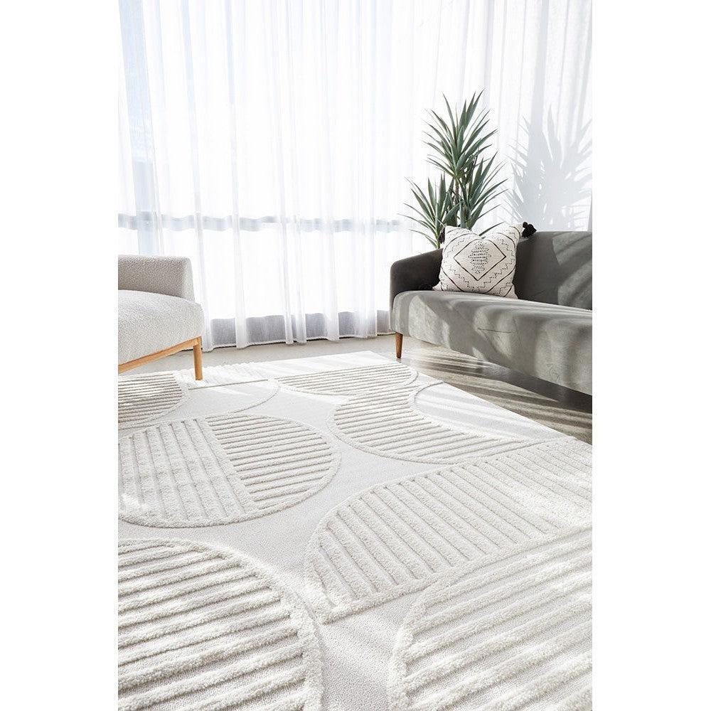 Lotus Leo White Rug featuring circular pattern in ivory, cream and light grey on white background, hand-tufted wool