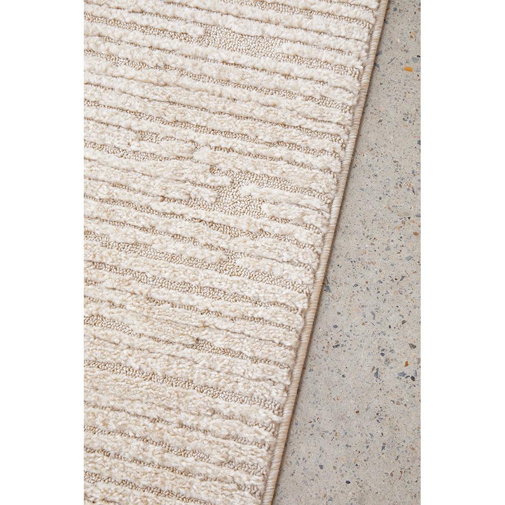 Marigold Suri Natural Runner Rug featuring shaggy solid pattern in cream beige on concrete floor, hand-tufted wool