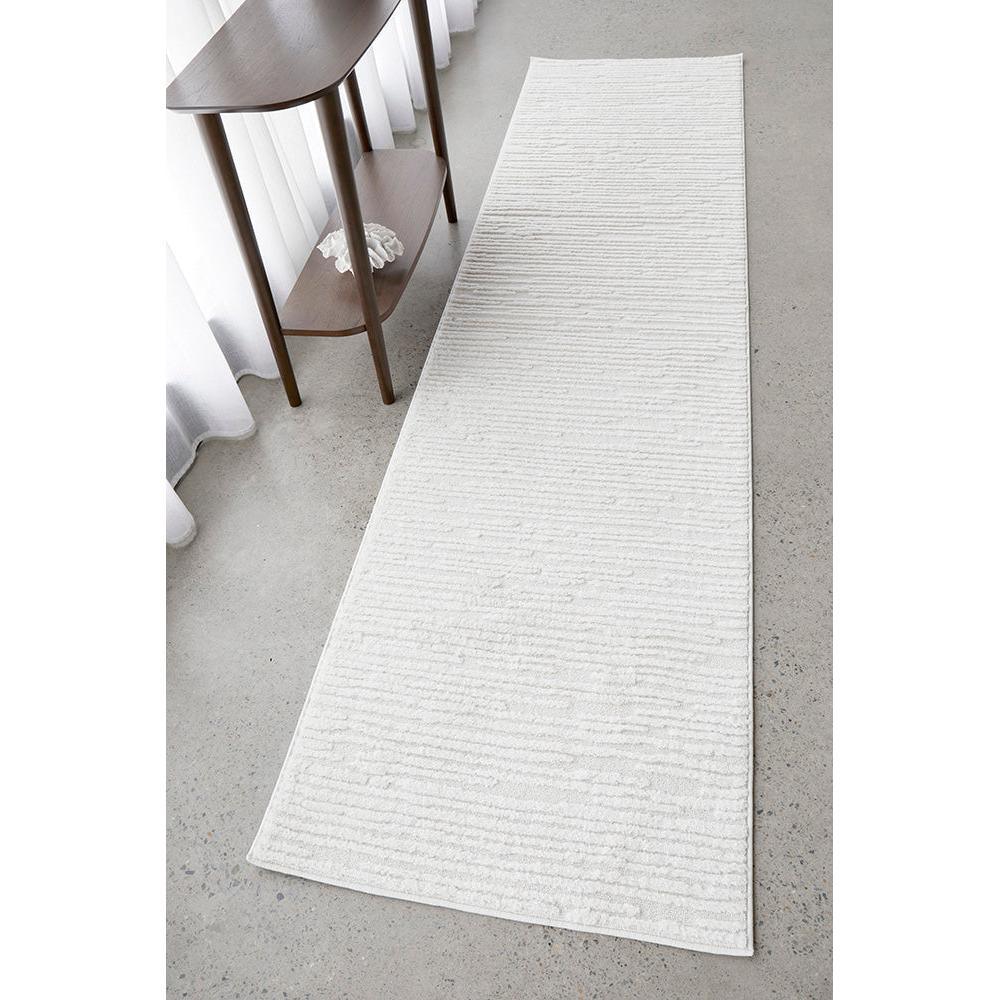 Marigold Suri White Runner Rug featuring subtle linear texture in white, ivory and light grey on pale grey floor, machine-made rug