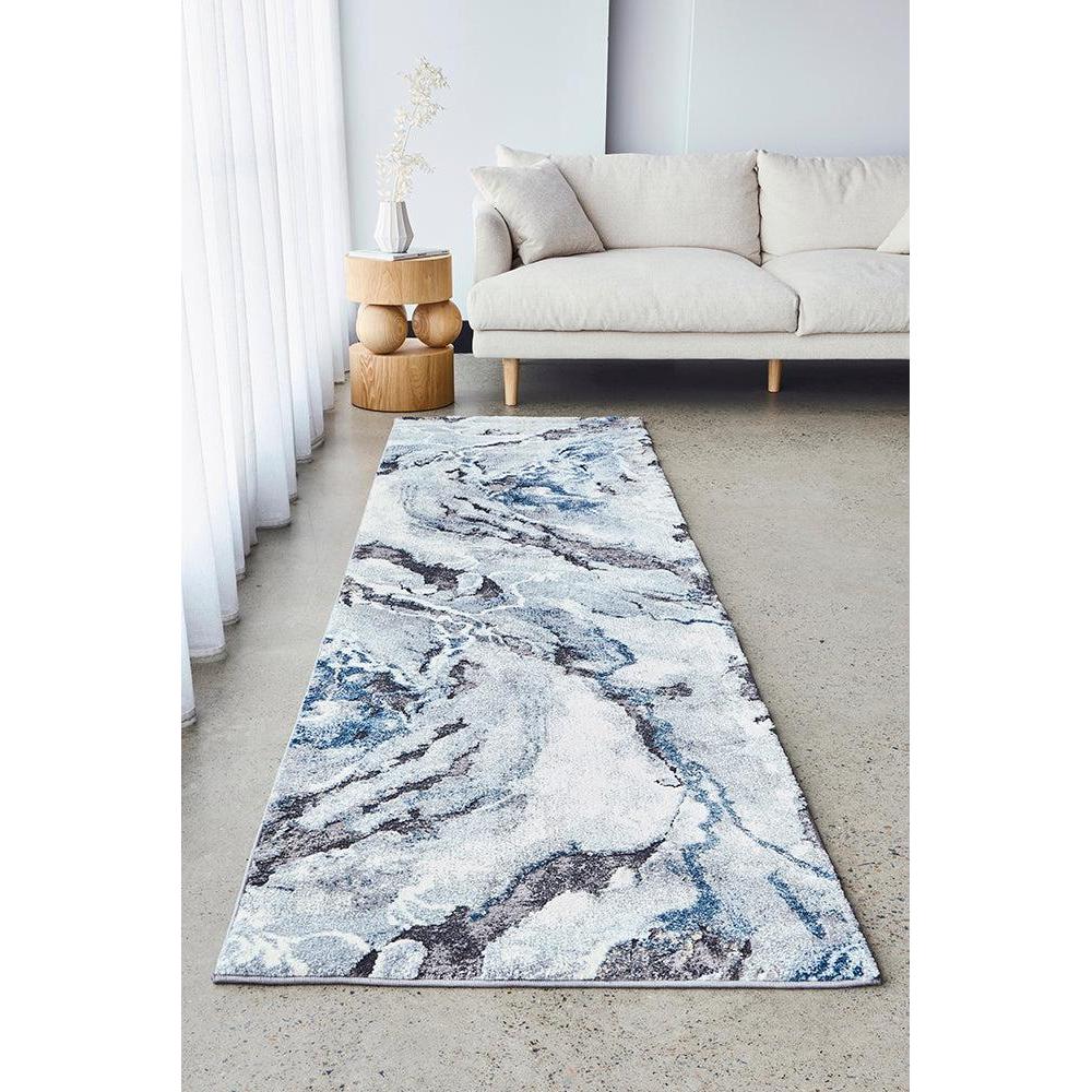 Marble-patterned rug on a concrete floor in a modern living room.