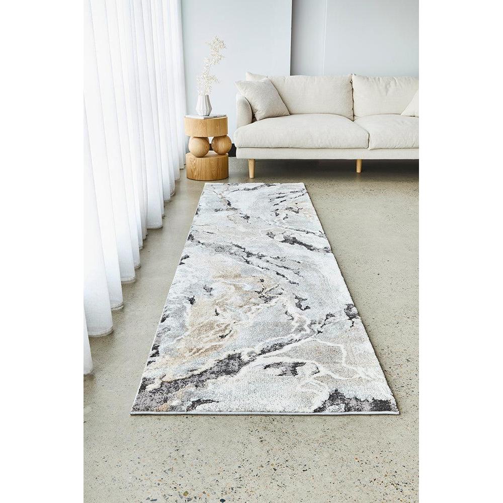 Marble-patterned rug on a light-colored floor in a living room setting.