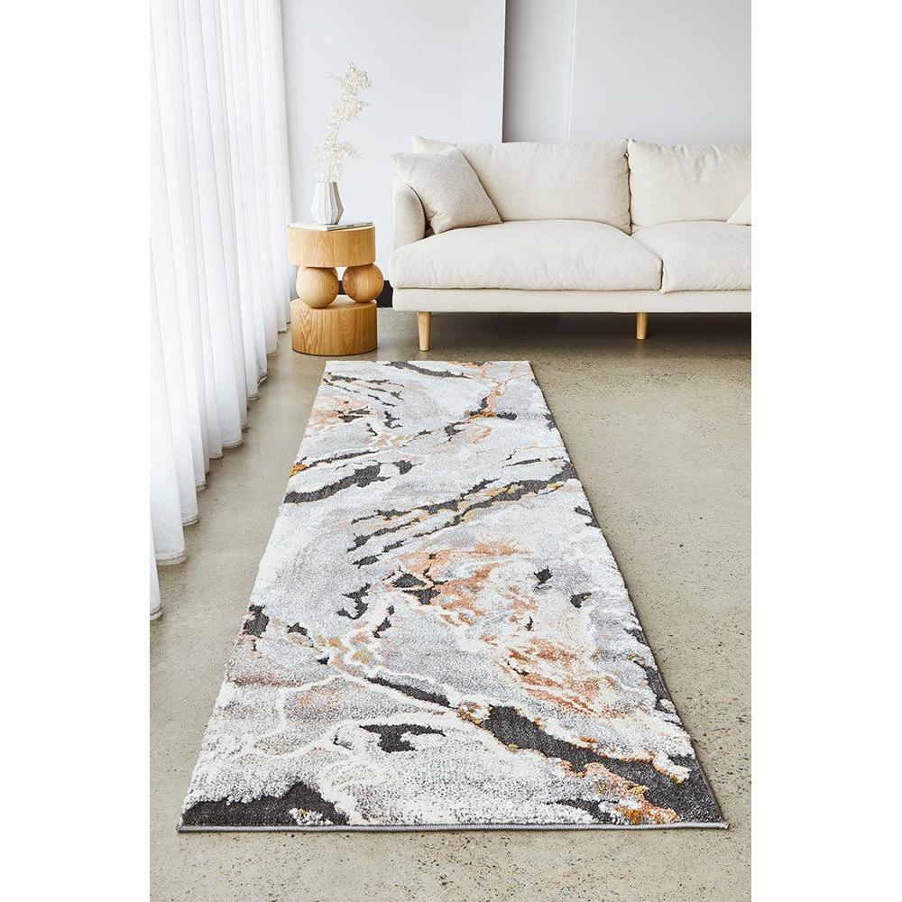 Long, narrow area rug with abstract pattern in a living room setting.