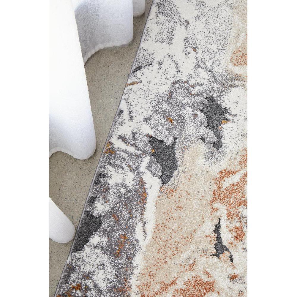 Close-up of a textured area rug with a marble-like pattern on a neutral background.