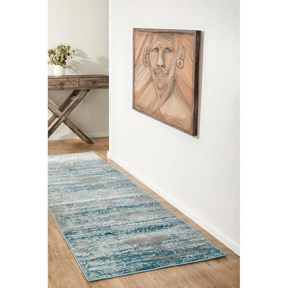 Lux Olivia Blue Runner Rug featuring distressed abstract pattern in teal, blue and cream on pale background, hand-tufted wool