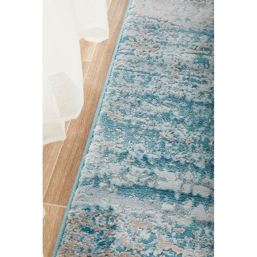Lux Olivia Blue Runner Rug featuring abstract distressed pattern in teal blue, sky blue and cream on light beige background, machine-made rug