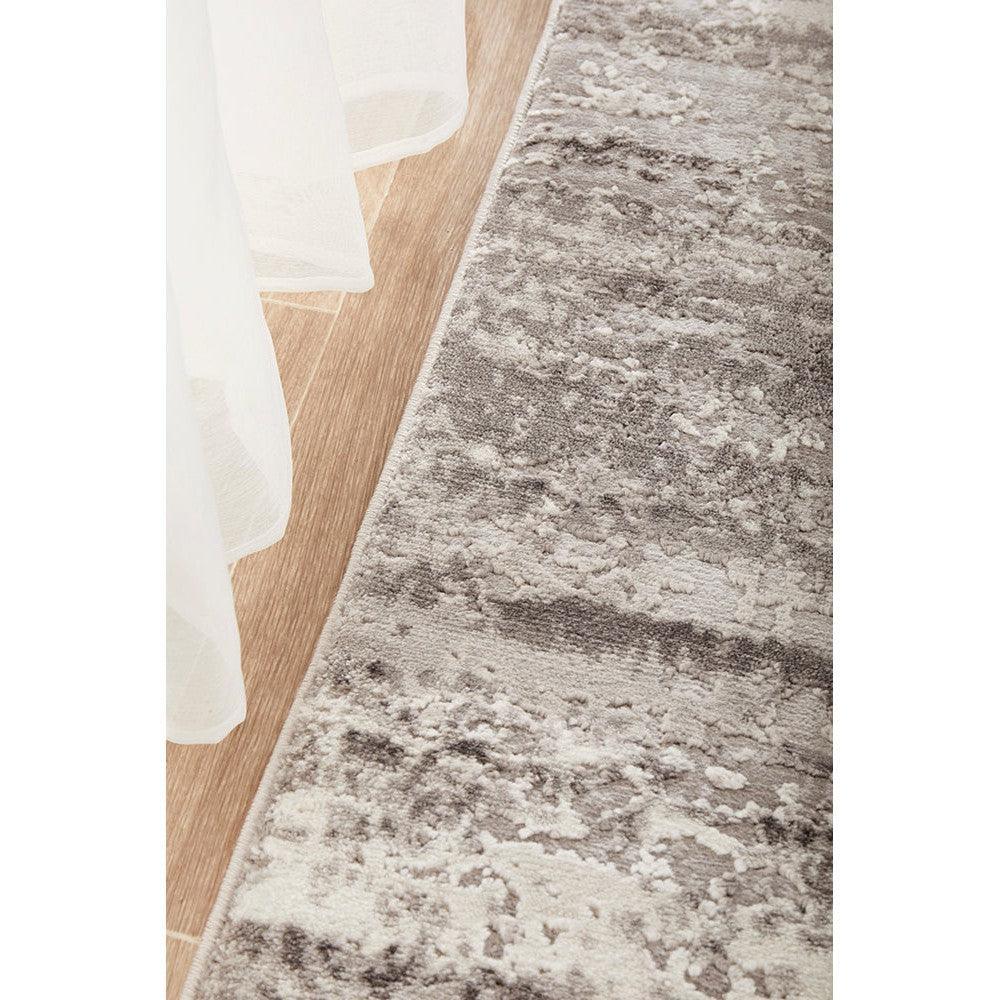 Lux Sophia Silver Runner Rug featuring abstract marbled pattern in silver, charcoal and ivory on light wood background, machine-made polyester