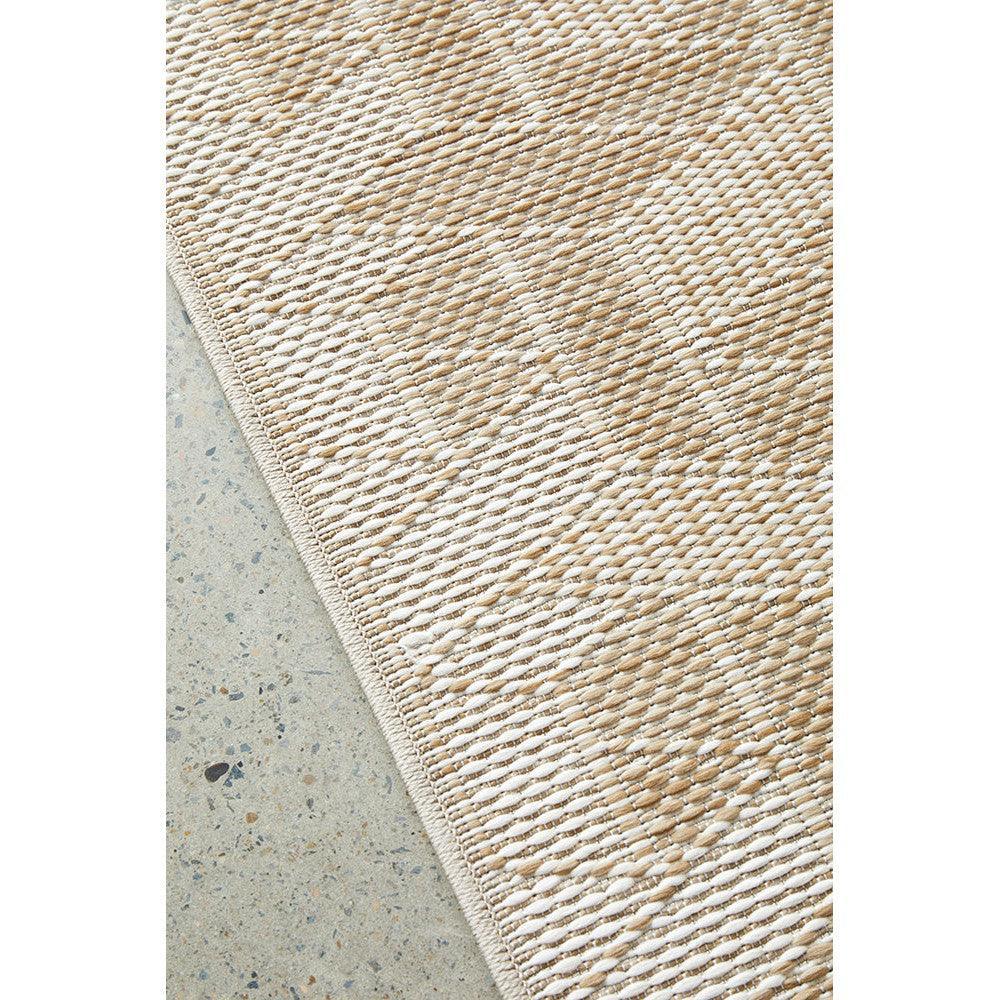 Patio Kudo Natural Indoor-Outdoor Rug featuring woven striped pattern in beige, cream and taupe on concrete, handwoven fibre