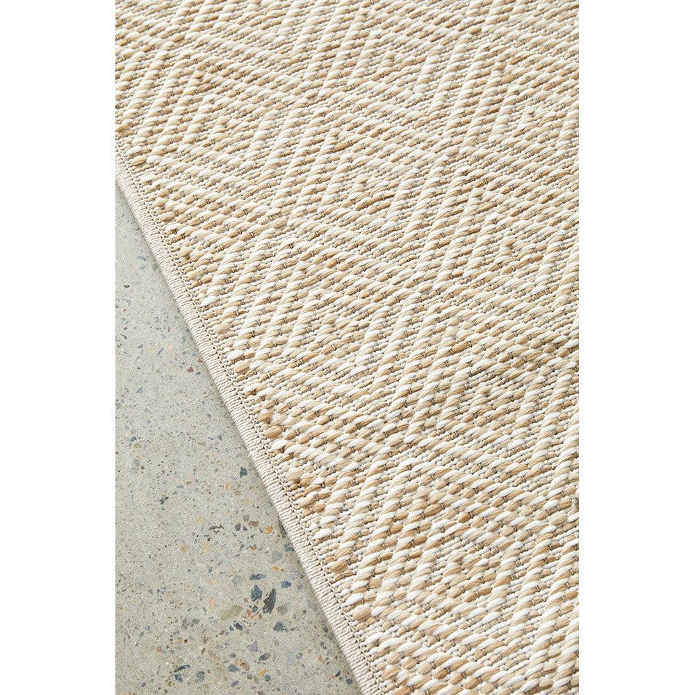 Patio Misty Natural Indoor-Outdoor Rug featuring diamond geometric weave in beige and ivory on pale background, handwoven jute
