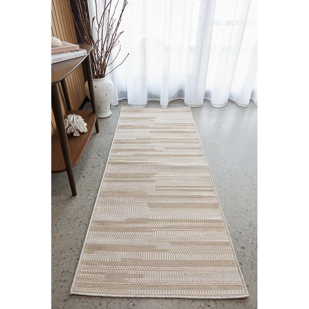 Patio Tilda Natural Runner Indoor-Outdoor Rug featuring striped pattern in beige, ivory and taupe on light grey floor, machine-woven polypropylene