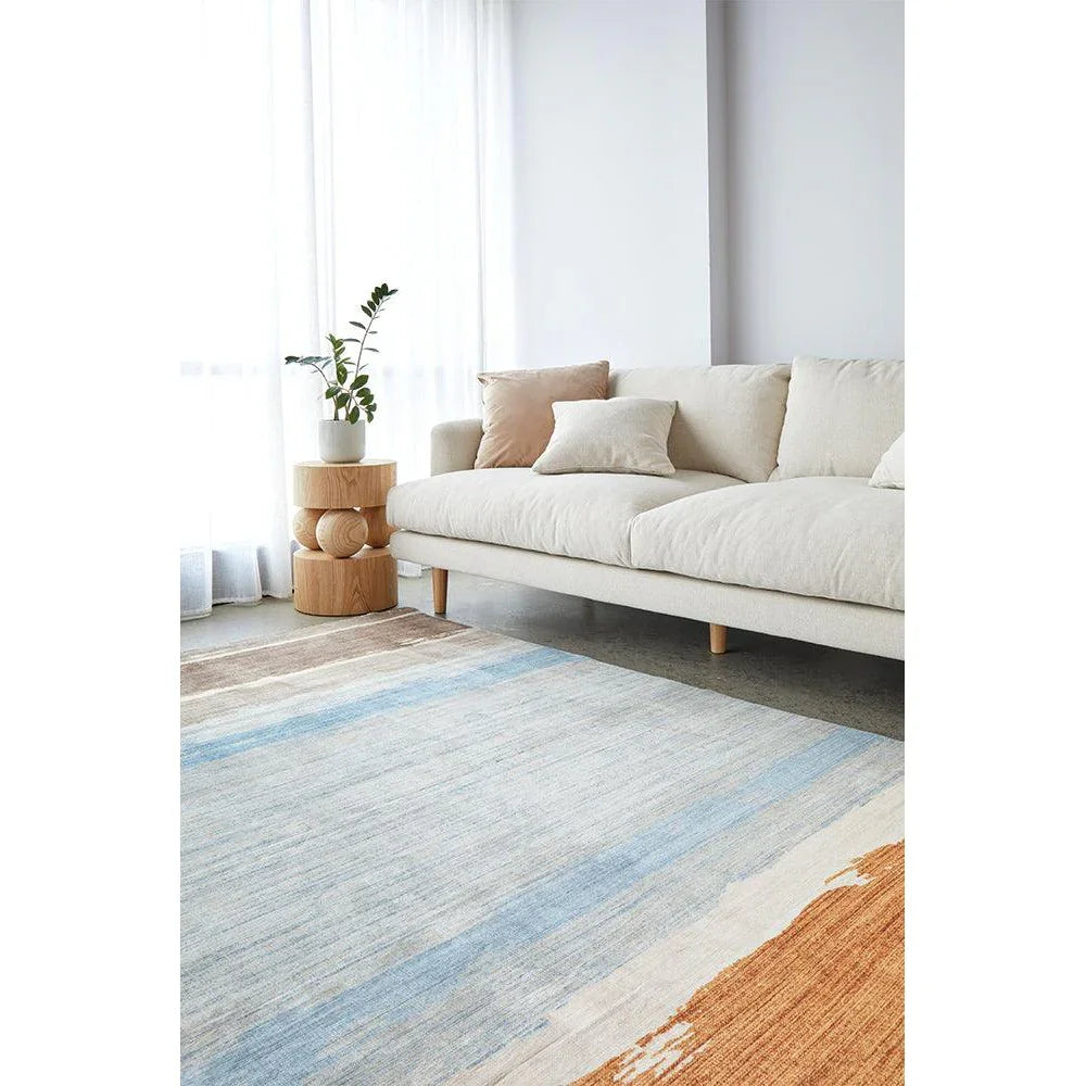 Revive Brody Tan Washable Rug featuring striped pattern in light blue, sky blue and cream on beige background, machine-made polyester