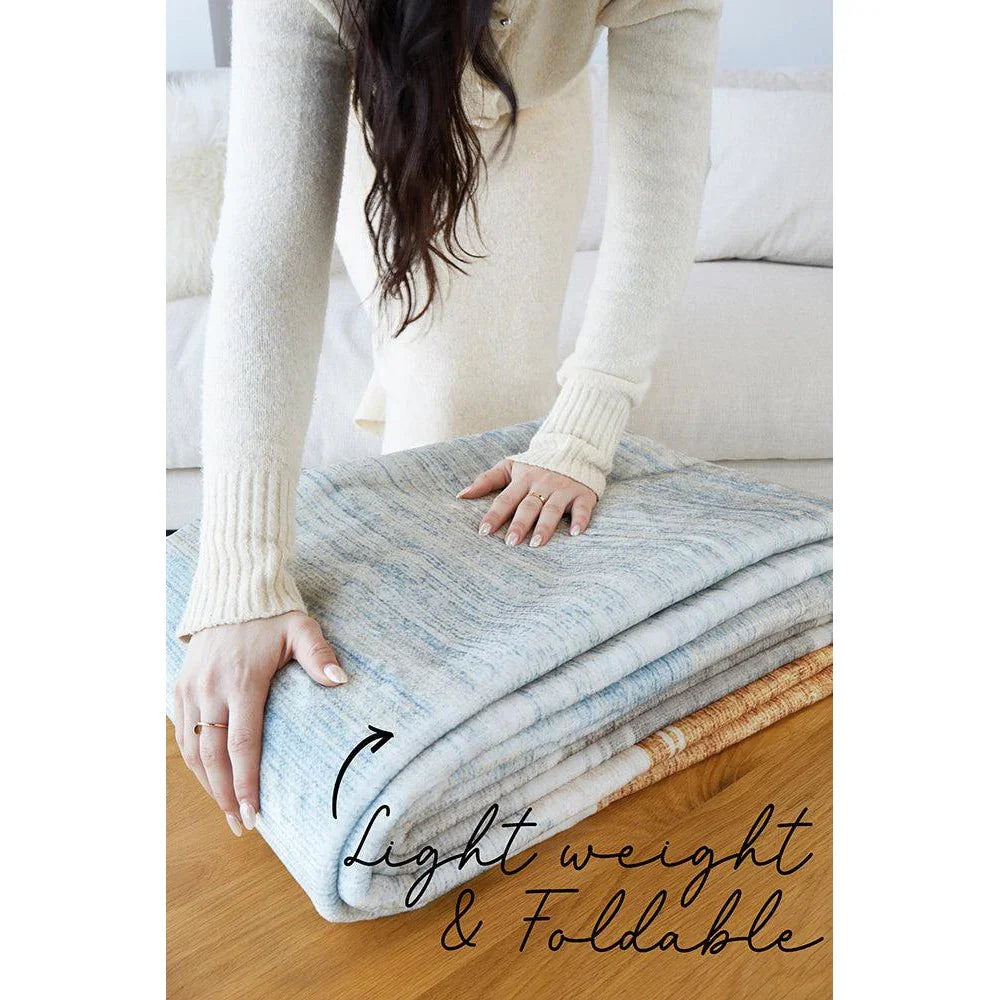 Revive Brody Washable Rug featuring light blue marbled pattern in light blue, ivory and cream on white background, machine-washable polyester
