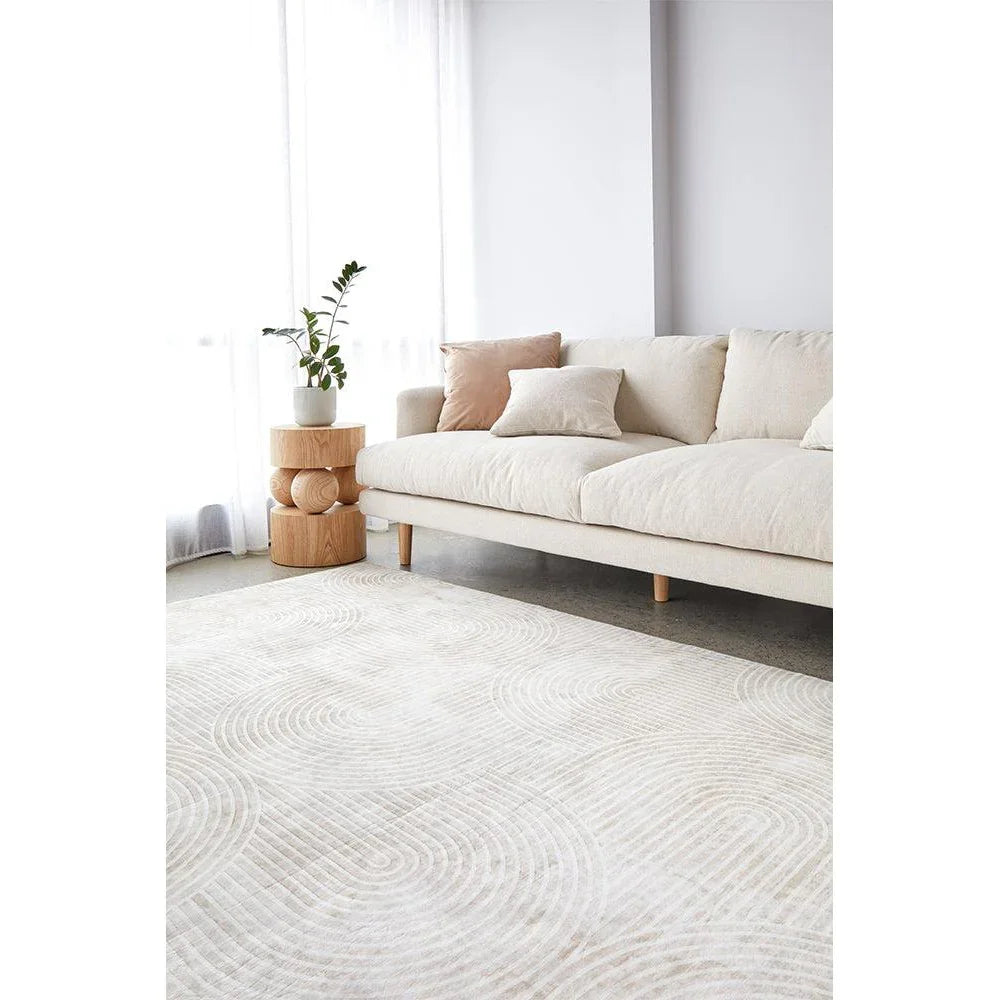 Revive Byron Natural Washable Rug featuring circular swirl pattern in cream, beige and taupe on ivory background, machine-made polypropylene