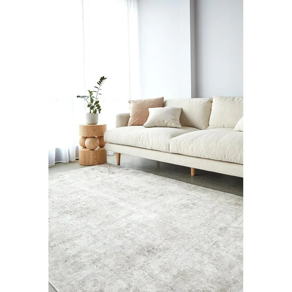 Revive Isla Marble Washable Rug featuring marble pattern in cream, ivory, beige and light grey on pale cream background, machine-woven rug