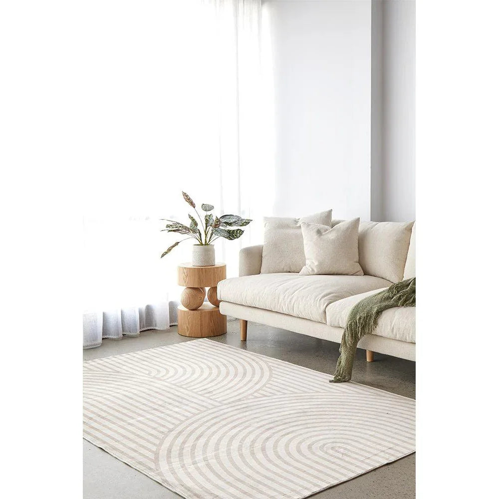 Revive Jett Natural Washable Rug featuring concentric circle pattern in cream, beige and taupe on ivory background, machine-made polyester