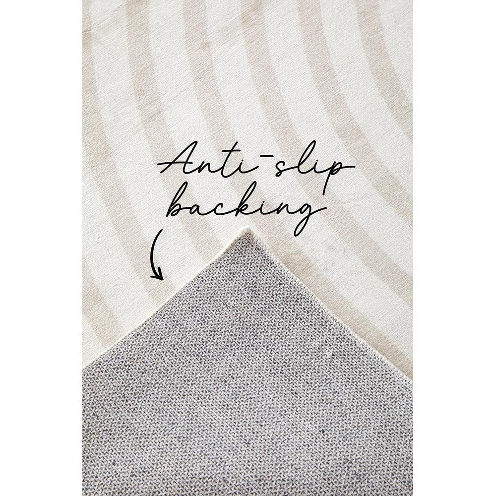 Revive Jett Natural Washable Rug featuring abstract curved stripe in cream, beige and taupe with anti-slip backing