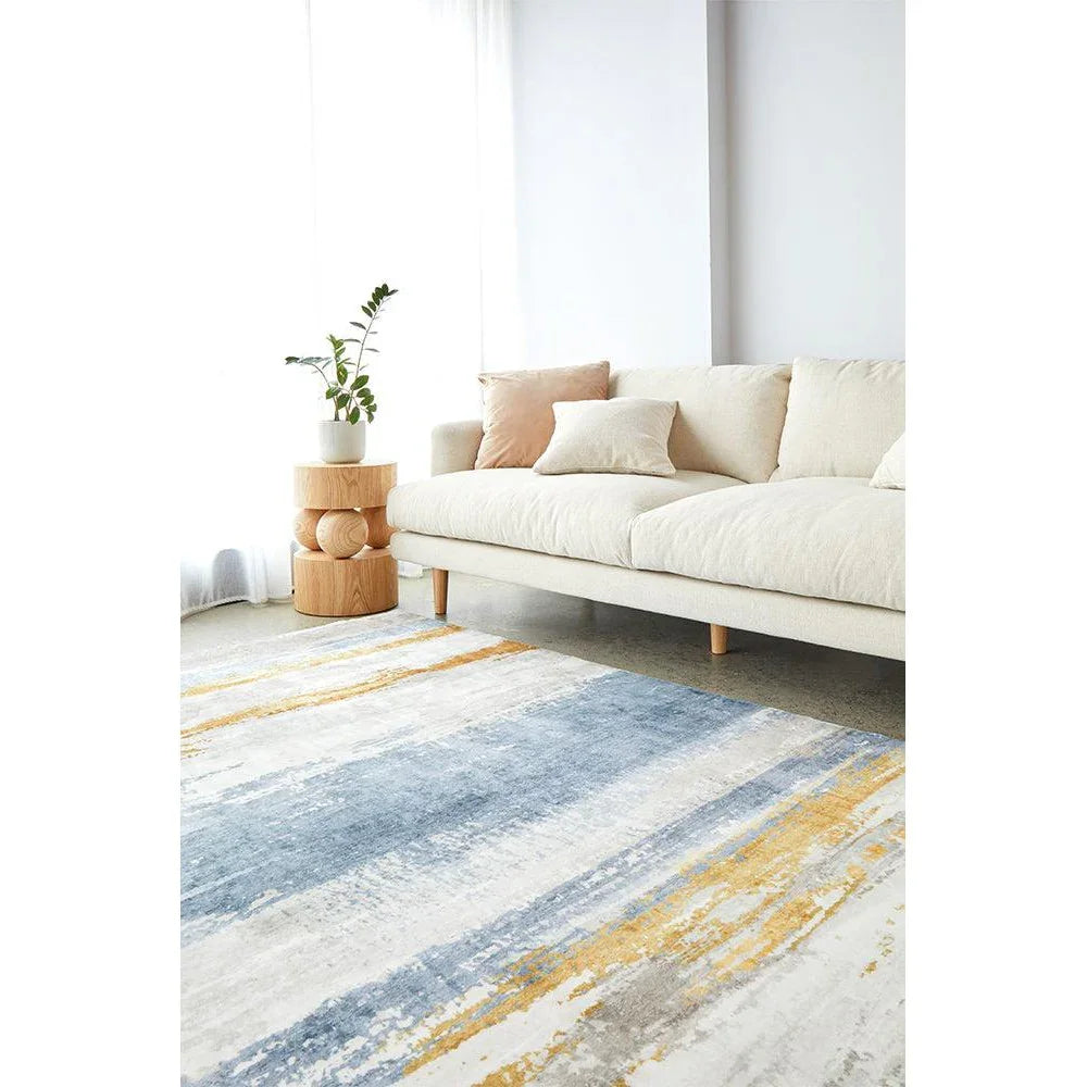 Revive Kyle Blue Washable Rug featuring abstract stripe pattern in blue, navy, mustard and cream on ivory background, machine-woven polyester