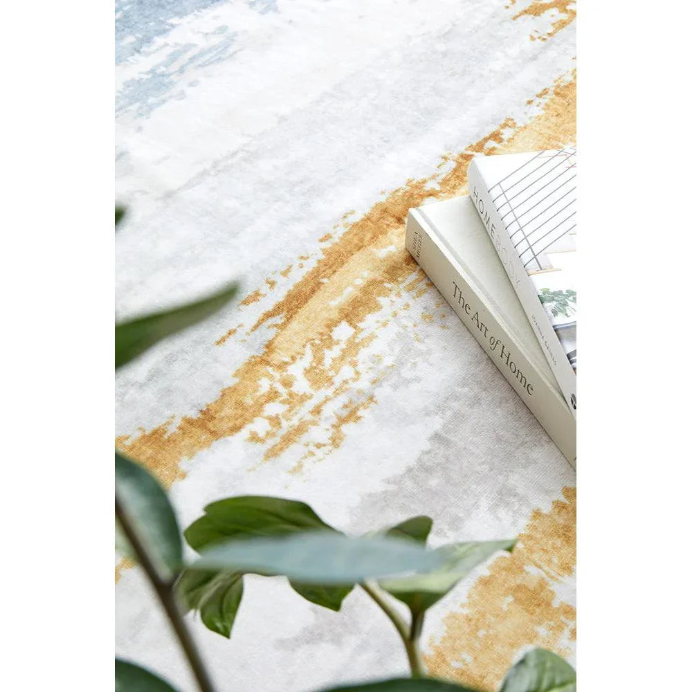 Revive Kyle Blue Washable Rug with abstract wash pattern in white, pale blue and ochre on cream background, machine-washable polyester
