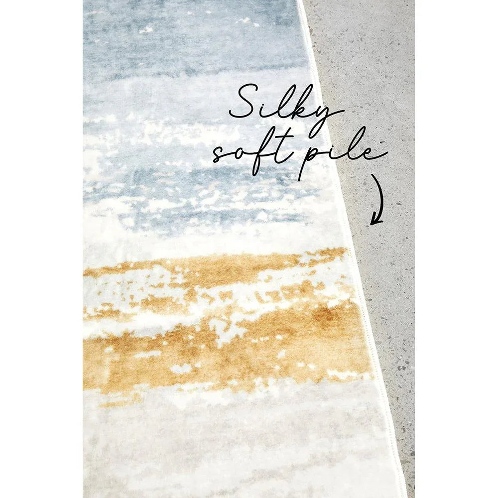 Revive Kyle Blue Washable Rug featuring abstract striped pattern in blue, mustard and cream on cream background, machine-washable polypropylene