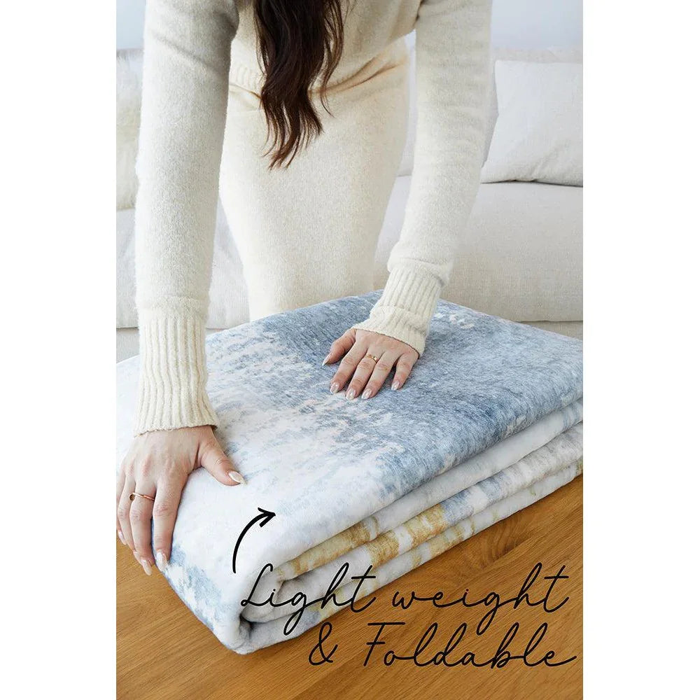 Revive Kyle Blue Washable Rug featuring light blue gradient pattern in sky blue, white on cream background, foldable fabric rug