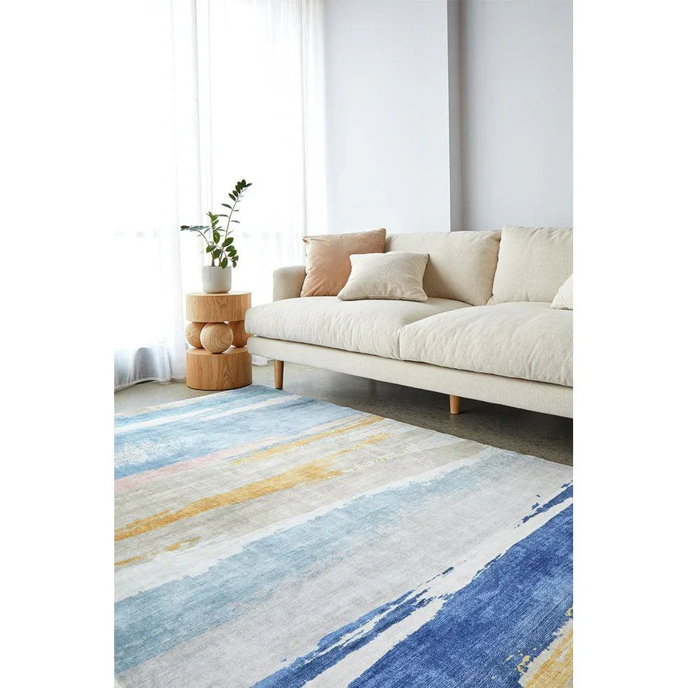 Revive Tyler Multi Washable Rug featuring abstract striped pattern in azure blue, navy, cream and yellow on light beige background, machine-woven polyester