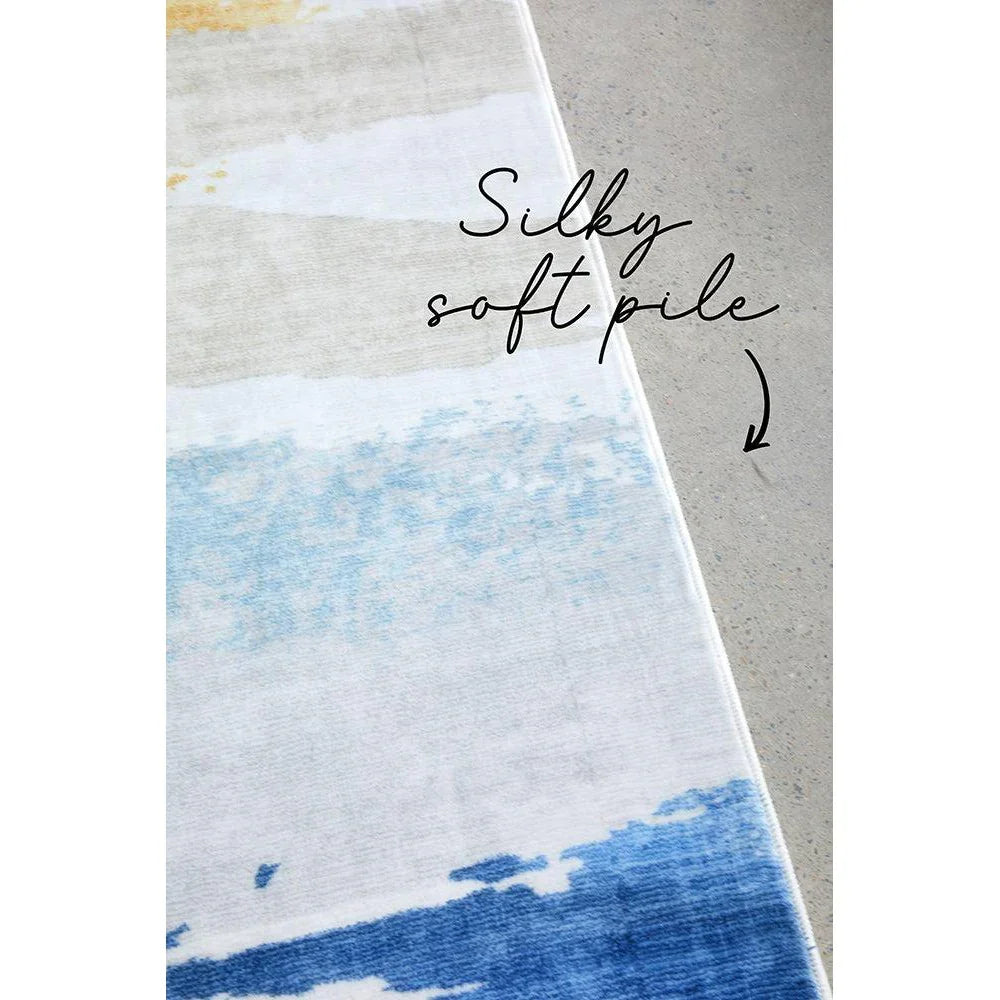 Revive Tyler Multi Washable Rug featuring abstract striped gradient in navy, sky blue, cream and beige on light grey background, machine-washable polyester
