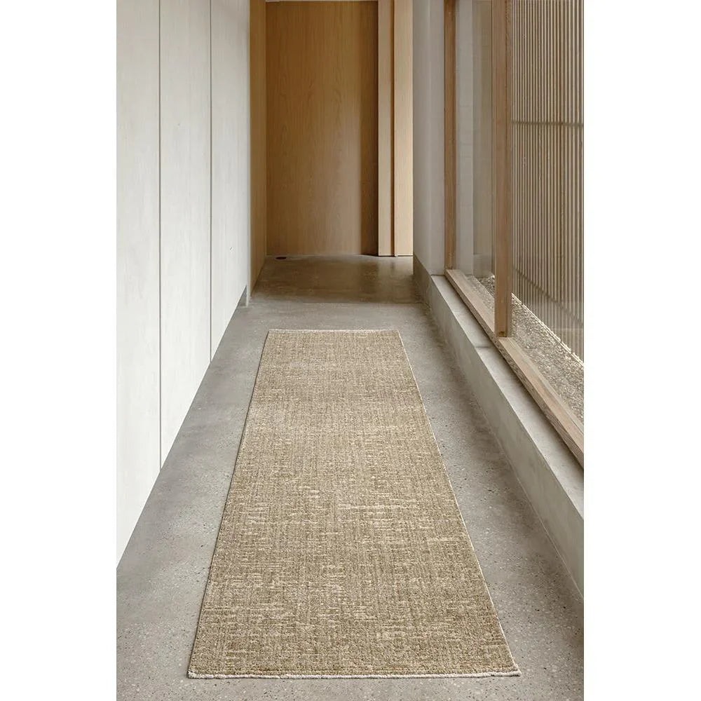 Steph And Gian Willow Wheat Runner Rug featuring woven texture in wheat, beige on grey floor, machine-woven natural fiber