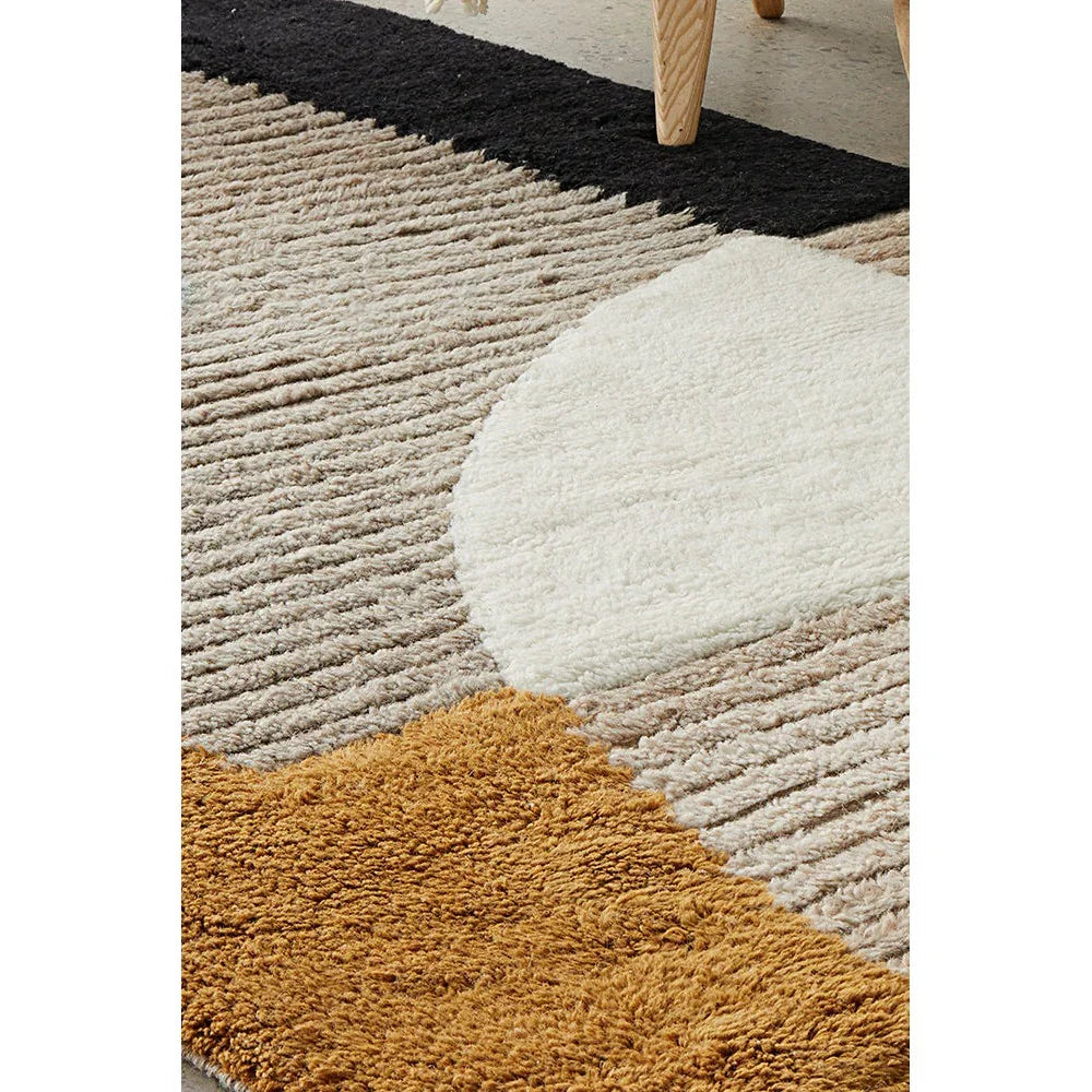 Summit Elroy Multi rug featuring abstract circular patchwork in cream, beige, taupe and ochre on warm brown background, machine-woven synthetics