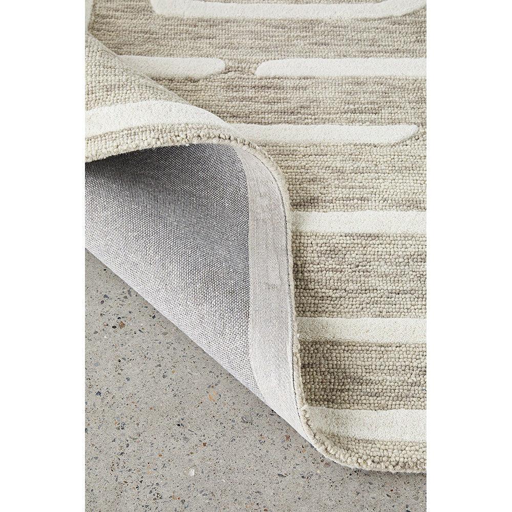 Summit Maze Linen rug featuring striped geometric pattern in ivory, cream and taupe on warm beige background, hand-tufted linen