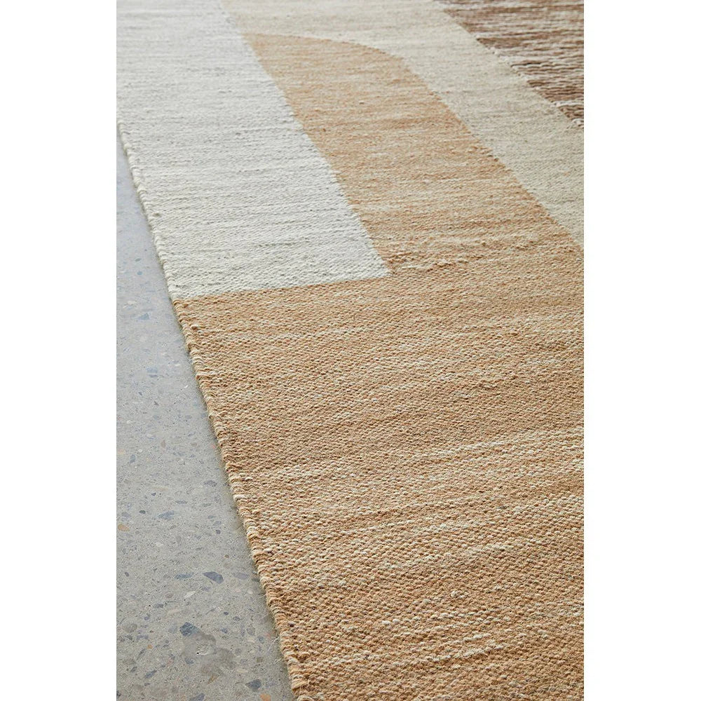 Summit Orb Toffee rug featuring geometric block pattern in toffee brown, cream, beige on light grey floor, hand-tufted wool