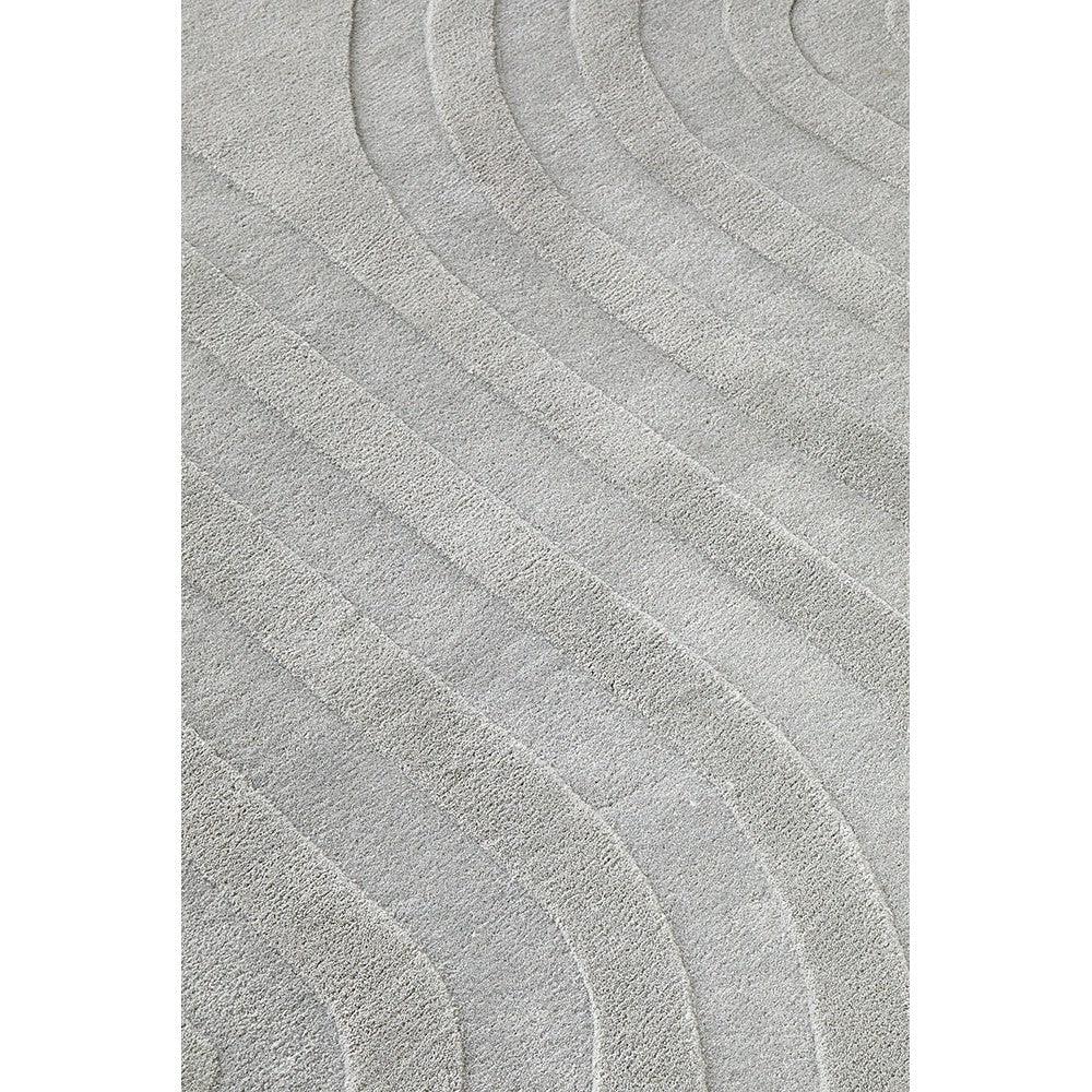 Summit Trail Grey rug featuring curved wave pattern in light and dark greys on soft grey background, machine-made polypropylene