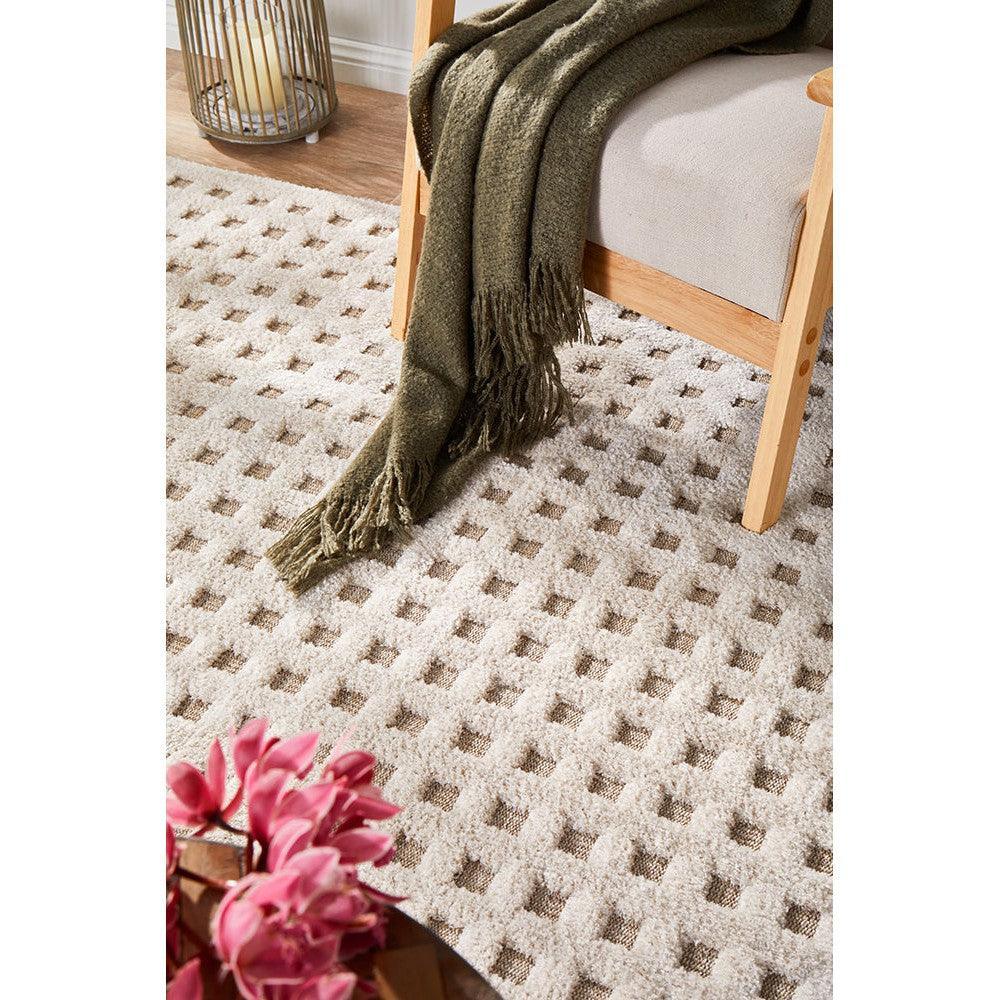 Villa Raine Natural Rug featuring geometric grid pattern in cream, beige and taupe on warm wood floor, machine-made wool
