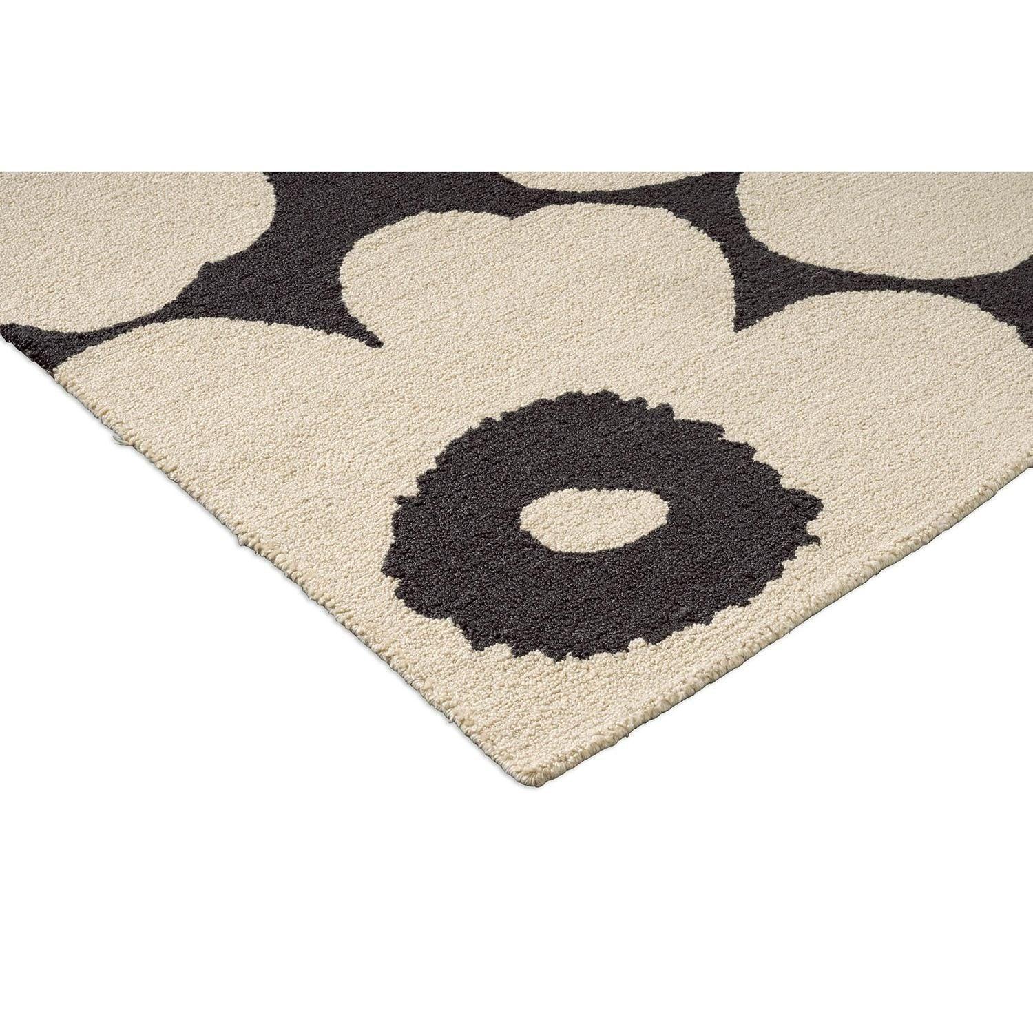 ICONIC RUGS Marimekko Unikko charcoal and ivory outdoor rug with oversized poppy design. Handtufted 100% recycled PET.