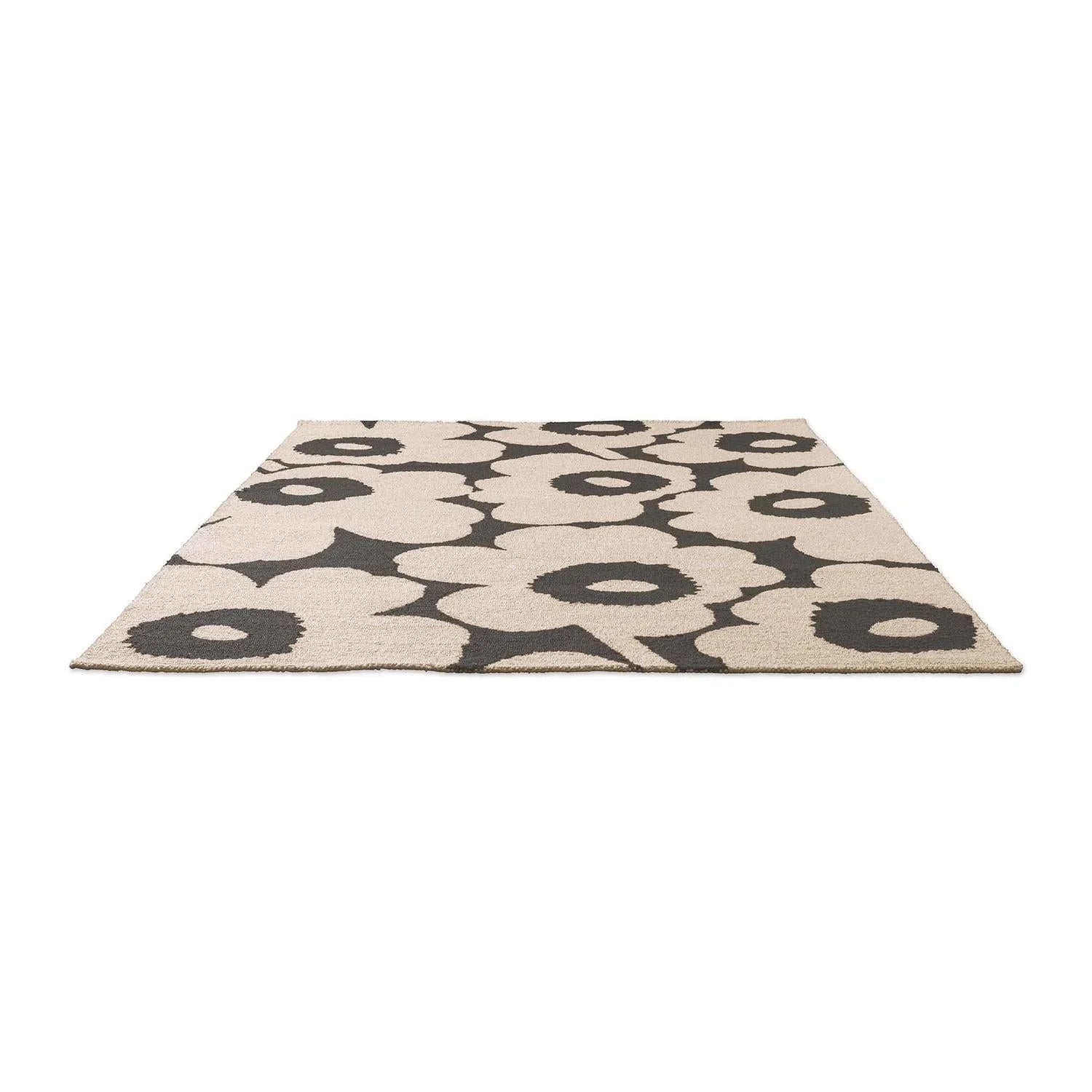 ICONIC RUGS Marimekko Unikko outdoor rug in charcoal and ivory. Features oversized poppy floral design, handtufted recycled PET, 11mm pile.