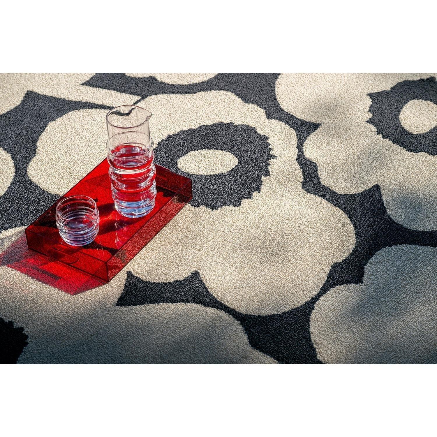 ICONIC RUGS Marimekko Unikko outdoor rug in charcoal and ivory, featuring a bold floral pattern. Made from recycled PET.