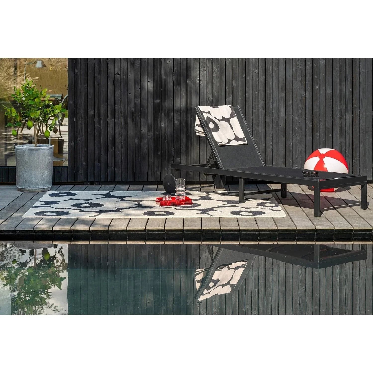 ICONIC RUGS Marimekko Unikko outdoor rug in charcoal and white, featuring oversized poppy design. Made from recycled PET.