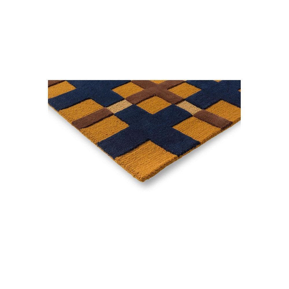 Brink & Campman Decor Milano rug featuring geometric checker pattern in navy blue, golden ochre and brown on cream background, hand-tufted wool
