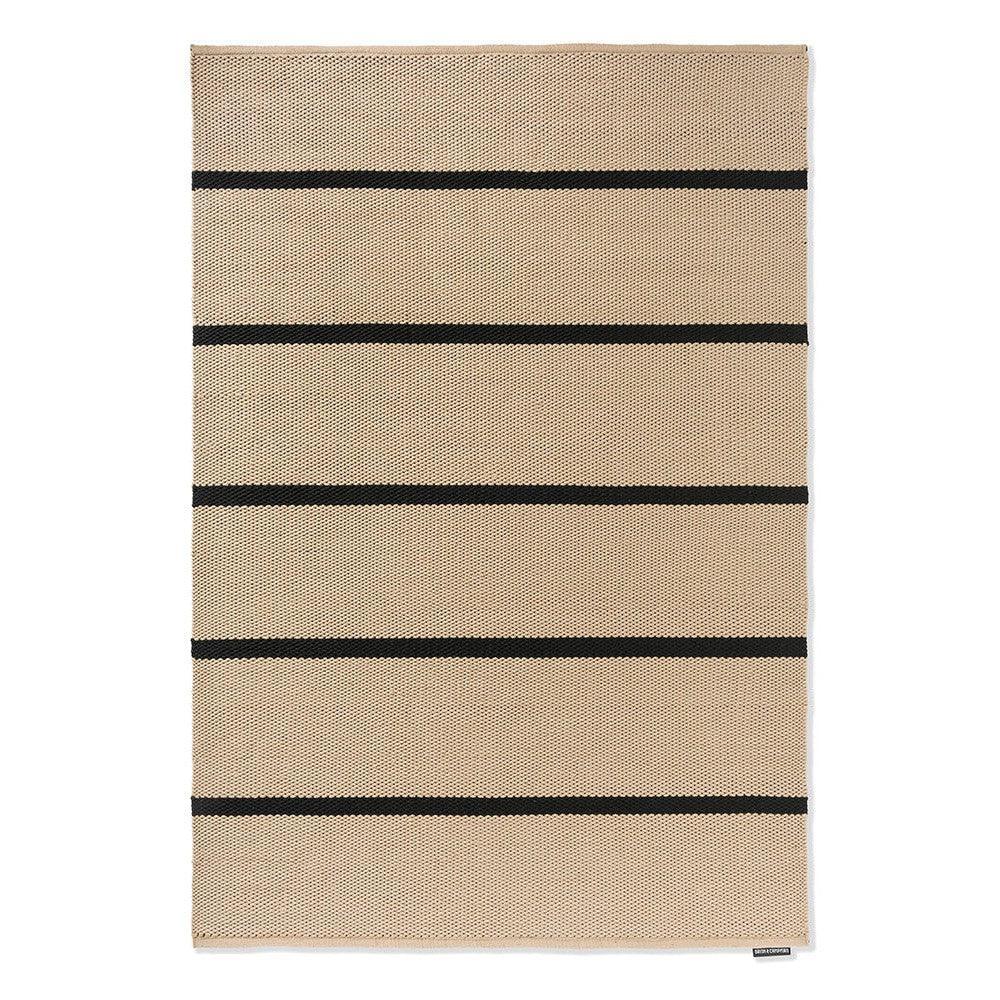 Brink & Campman Deck Charcoal Black Outdoor Rug featuring horizontal beige and black stripes on a light beige background, flatwoven polypropylene