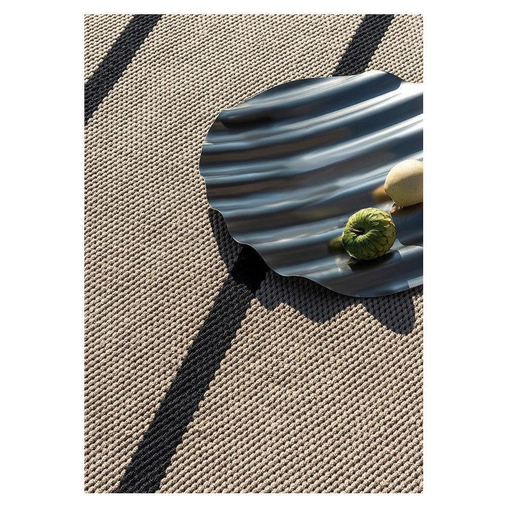 Brink & Campman Deck Charcoal Black Outdoor Rug featuring striped woven pattern in beige, taupe and charcoal on tan background, woven polypropylene
