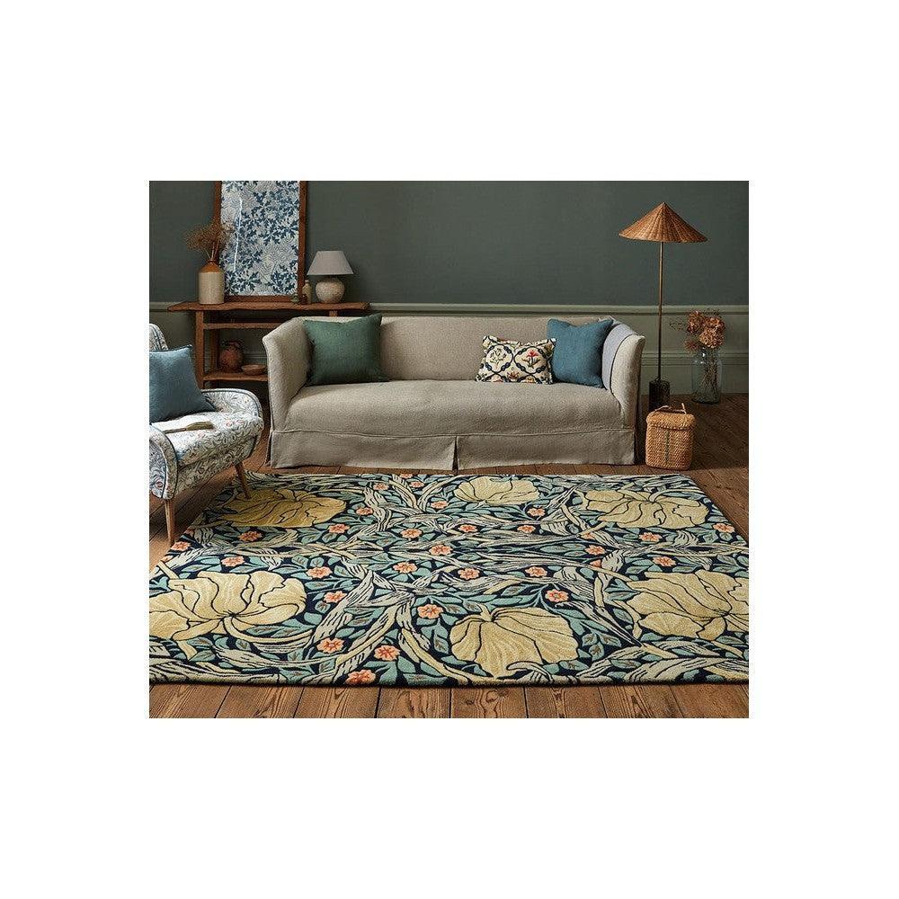 Morris & Co Pimpernel Indigo Designer Rug featuring botanical floral pattern in teal, beige and orange on teal background, hand-tufted wool