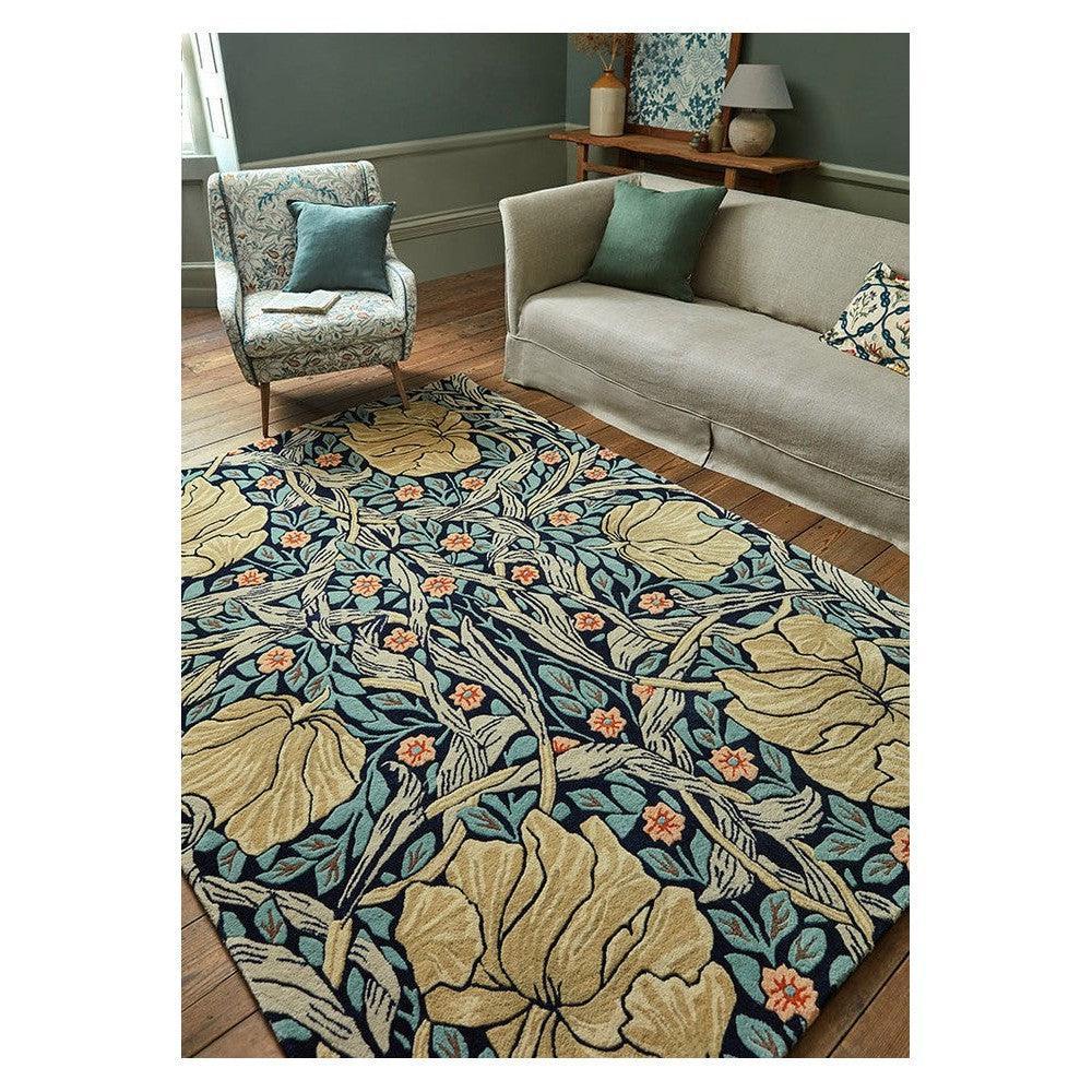 Morris & Co Pimpernel Indigo rug featuring floral pattern in teal, beige and coral on indigo background, hand-tufted wool