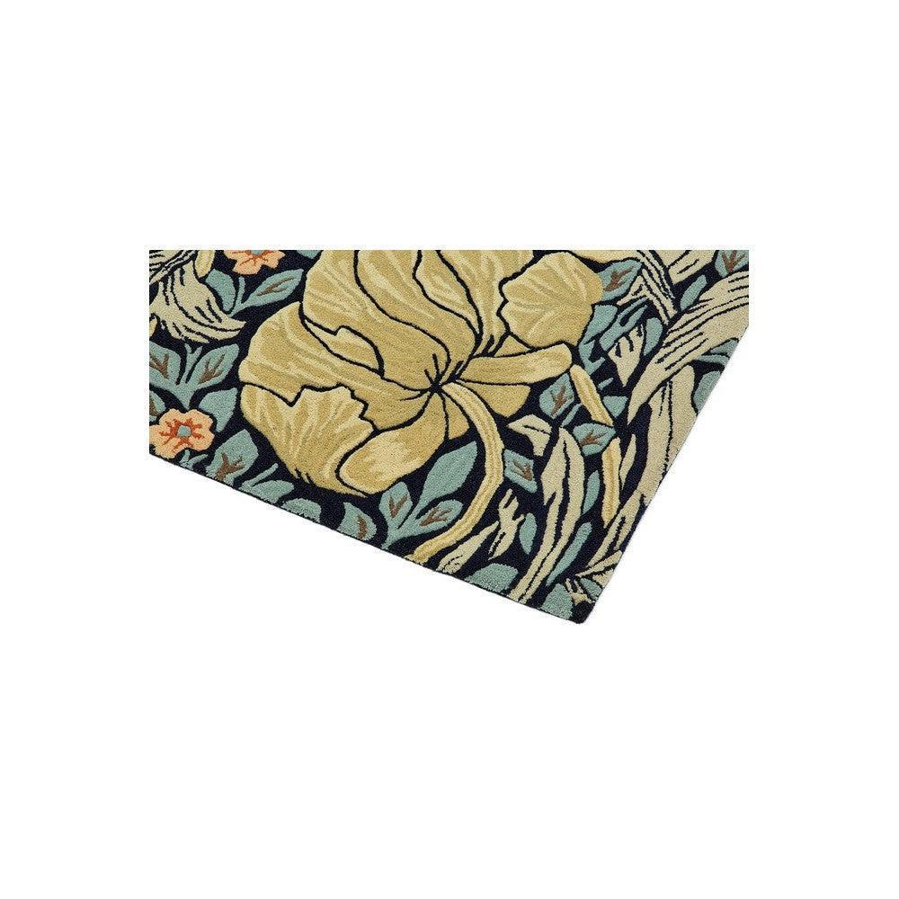 Morris & Co Pimpernel Indigo rug featuring botanical floral pattern in yellow, navy, teal, sage on dark navy background, hand-tufted wool