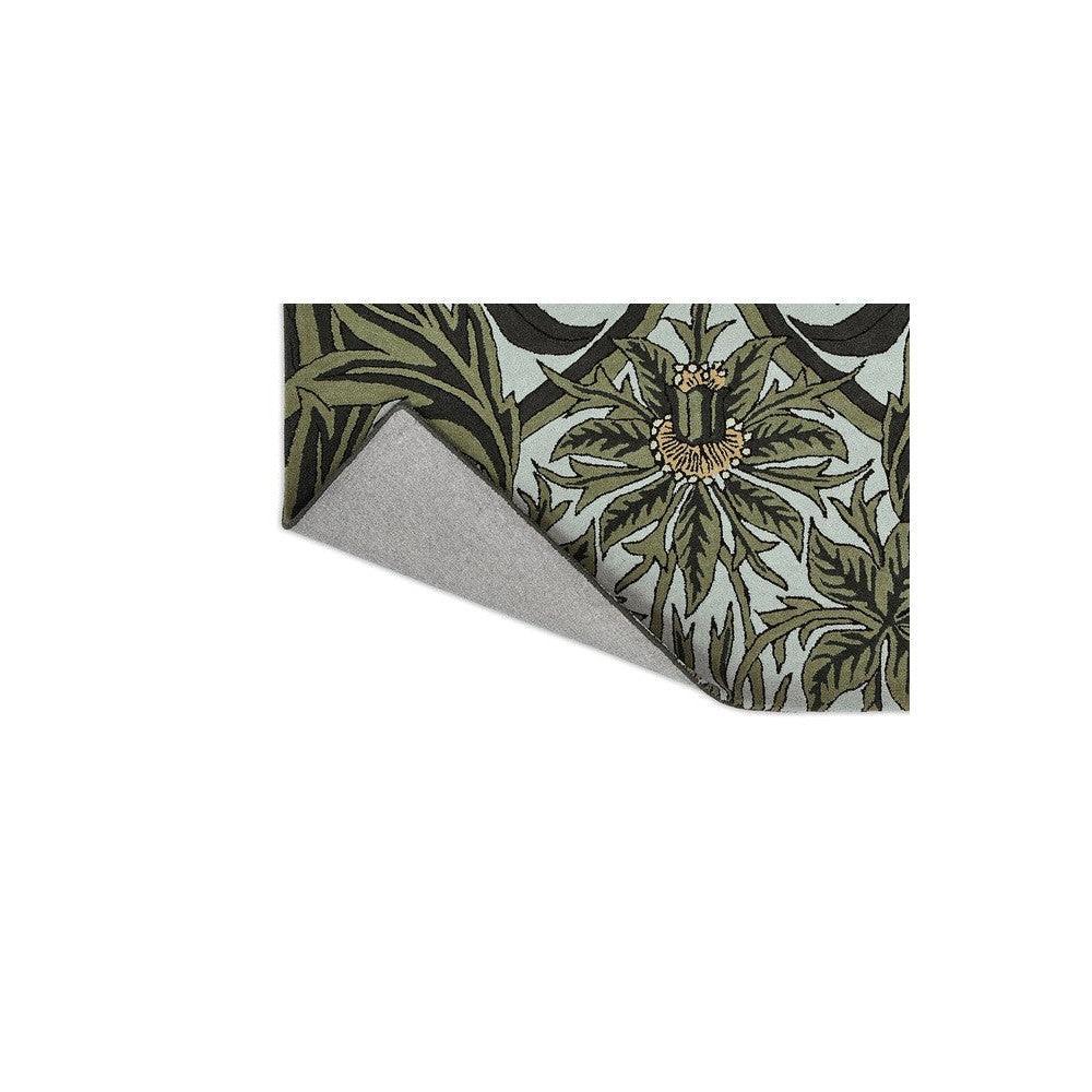Morris & Co Bluebell Leafy Arbour Green Designer Rug featuring botanical leaf pattern in olive and sage greens on pale blue background, machine-made wool