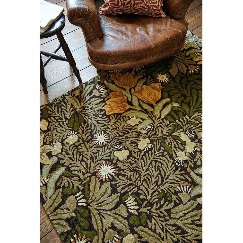 Morris & Co Bower Twining Vine Green Rug featuring floral vine in olive, sage, cream on dark green background, hand-tufted wool