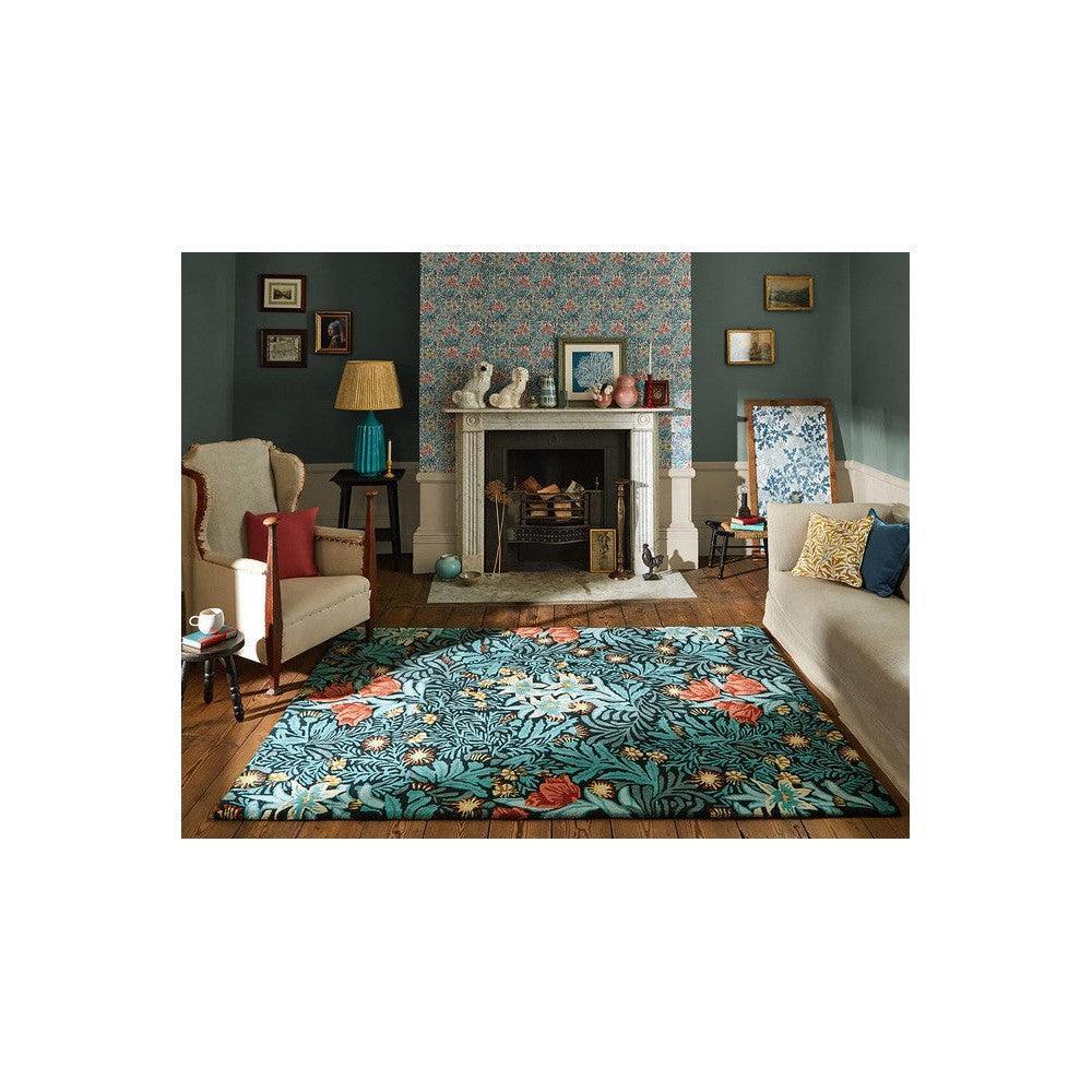 Morris & Co Bower Indigo Rug featuring botanical floral pattern in teal, coral-orange and cream on teal background, hand-tufted wool