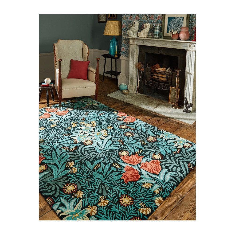 Morris & Co Bower Indigo Designer Rug featuring botanical floral pattern in teal, coral and ivory on teal background, hand-tufted wool