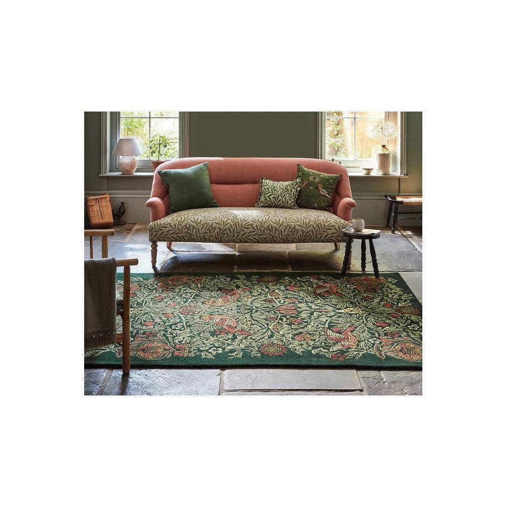 Morris & Co Bird Tump Green Designer Rug with botanical floral pattern in emerald, sage, cream and pink on deep green, hand-tufted wool